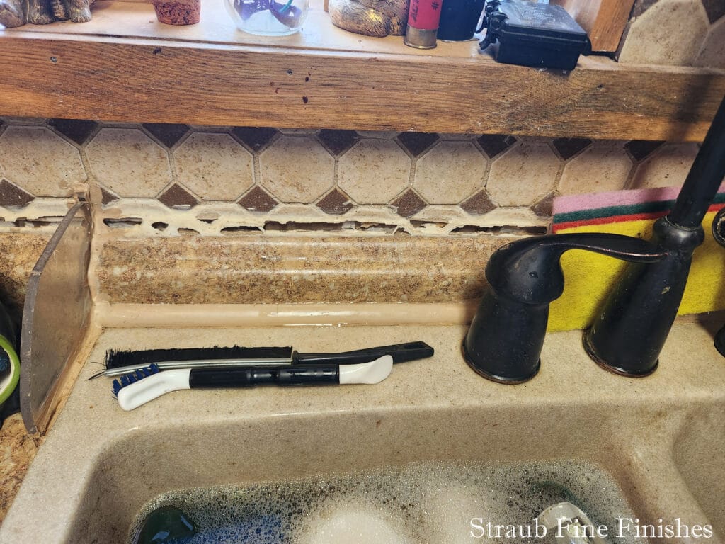 Photo showing damages to back splash installation that were done during water/mold remediation by a restoration contractor.