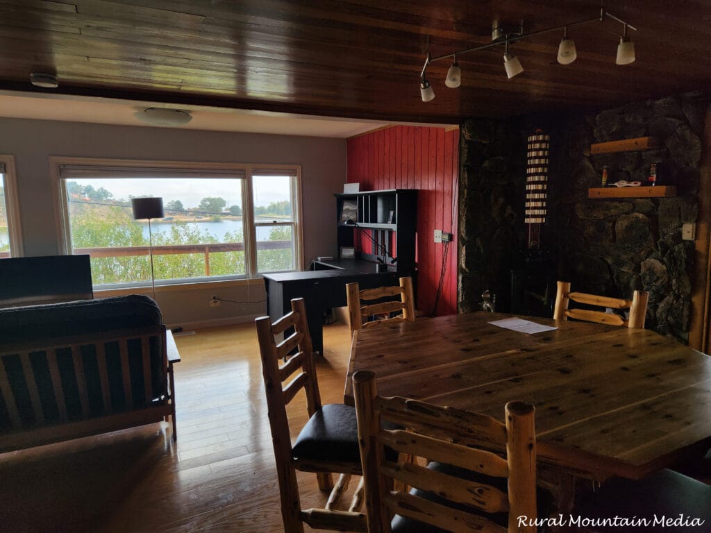 Cabin dining room stone fireplace log table